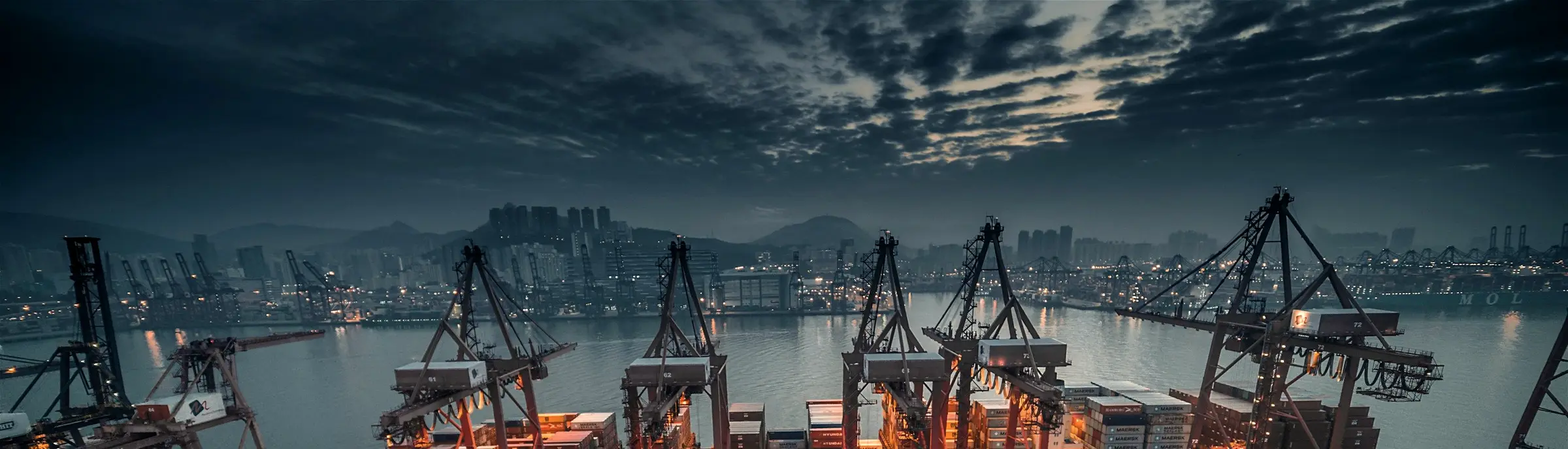 Container cranes at a port at dusk